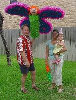 Miranda, mom & dad pose by the piñata
